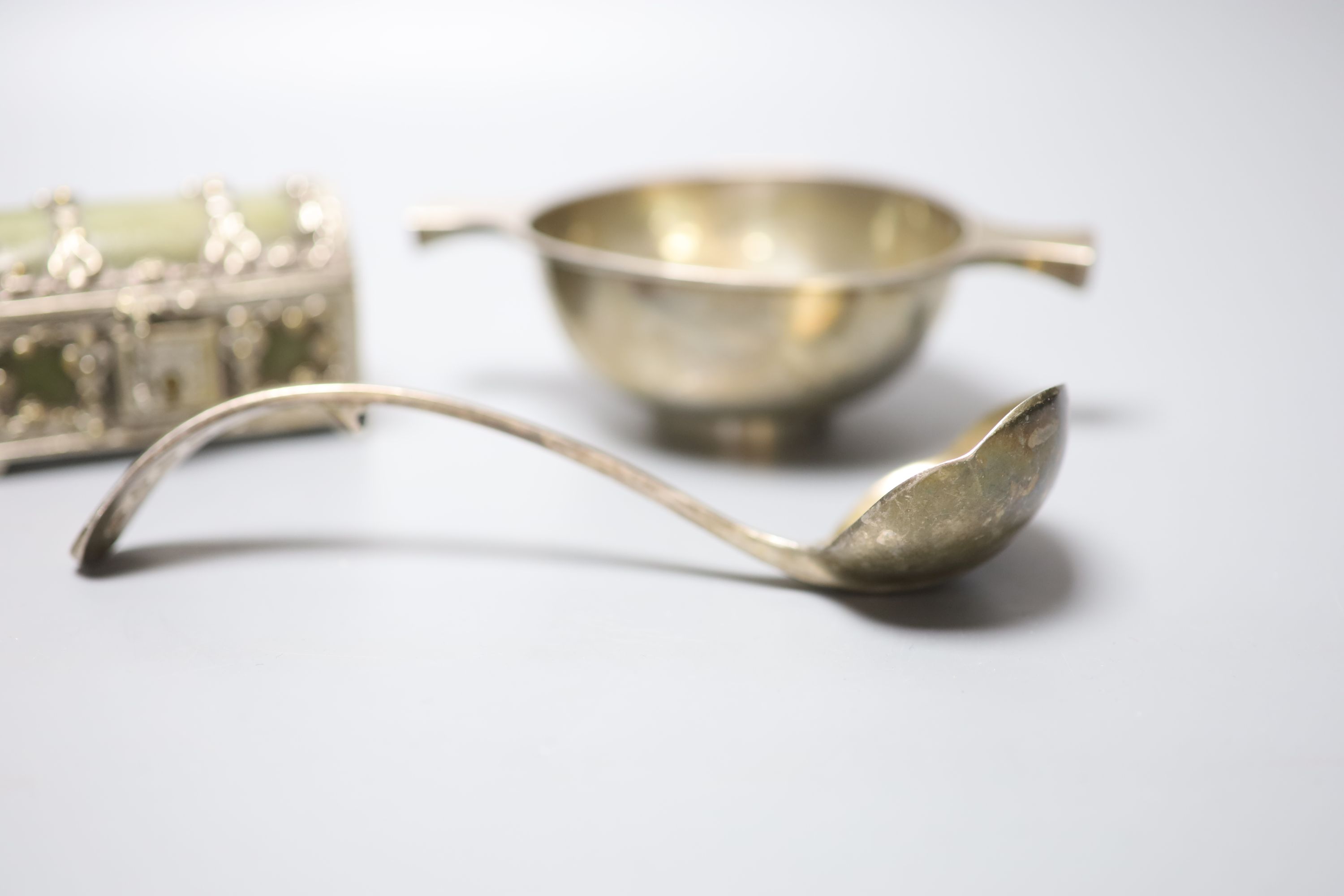 A George V Scottish silver quaich, Edinburgh, 1934, 15.3cm, a plate mounted leatherette casket, two white metal caddy spoons, etc